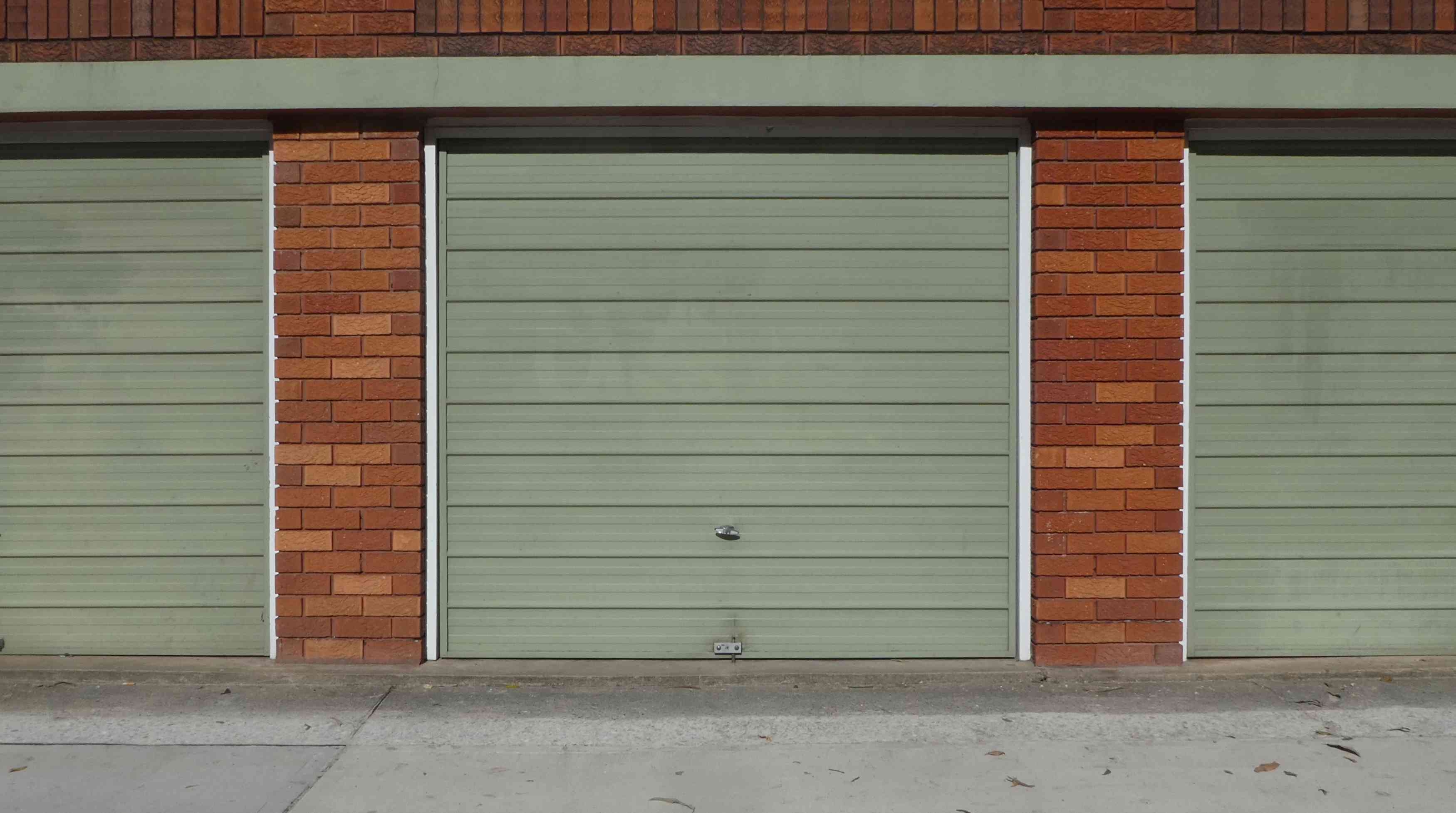 green-garage-door-brick-frame-street-view-2N8RDME(1) 3 Main Types of Garage Door Springs and Accessories